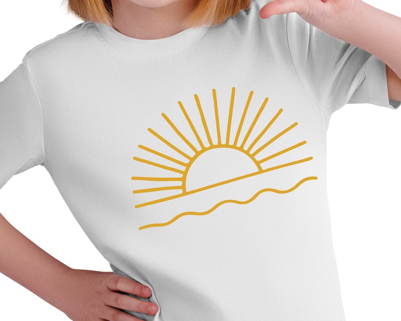 May include: A white t-shirt with a gold outline of a sun setting over the ocean.