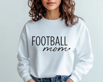 May include: White sweatshirt with black text that reads "FOOTBALL mom" with a small heart after the word "mom".