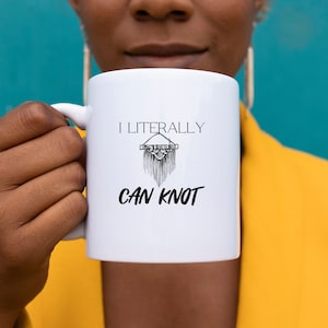 May include: White ceramic mug with a black graphic that says "I literally can knot" with a drawing of a macrame hanging.