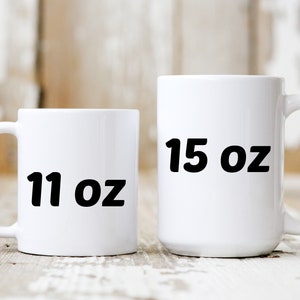 May include: Two white ceramic mugs with black text. The smaller mug is 11 oz and the larger mug is 15 oz.