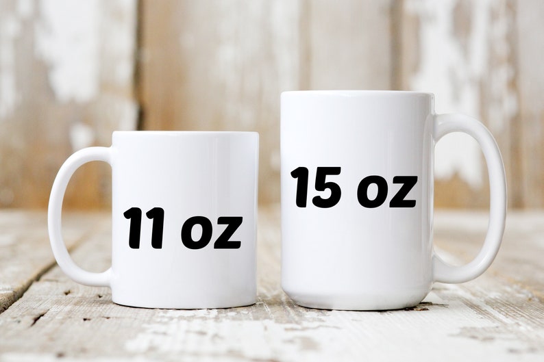 May include: Two white ceramic mugs with black text. The smaller mug is 11 oz and the larger mug is 15 oz.
