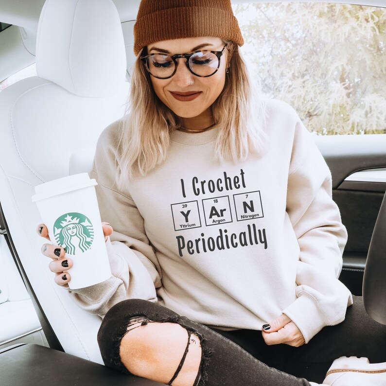 May include: A white sweatshirt with the text "I Crochet Periodically" and a graphic of the chemical elements Yttrium, Argon, and Nitrogen.