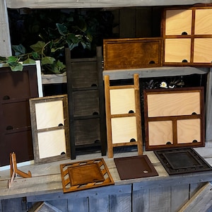 May include: A collection of wooden picture frames in various sizes and styles, including a three-section frame, a two-section frame, and several single frames. The frames are all made of natural wood and have a rustic, farmhouse aesthetic.