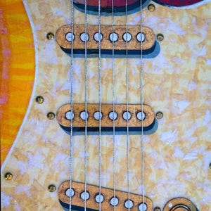 Puede incluir: Un cuerpo de guitarra el&eacute;ctrica con tres pastillas acabadas en pan de oro y plata. El golpeador est&aacute; cubierto de papel de seda finamente cortado para un efecto perlado. El texto dice: The pickups are a mixture of 3D AND 2D effects and are finished in gold & silver leaf. The pick guard finish is comprised of finely cut tissue paper to suggest a pearlized visual effect. CONNER GUITART.