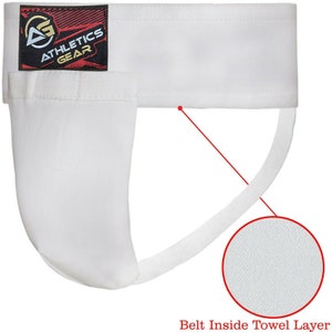 May include: White athletic supporter with a white elastic strap and a white towel layer. The supporter has a black label with the text "Athletics Gear" in gold letters.