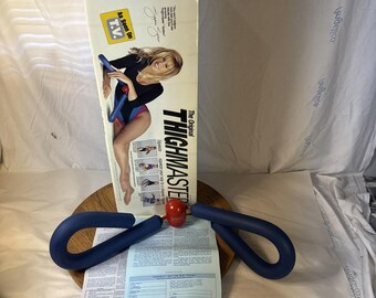 Attrezzo per esercizi ThighMaster originale del 1991 di Suzanne Somers, visto in TV, con scatola.