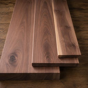 Tablas de nogal negro: varios grosores, anchos y longitudes. Madera secada al horno, cepillada, aplanada y escuadrada.