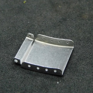 May include: A silver metal watch band connector with multiple holes for adjusting the size.