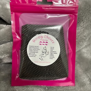 May include: A pink resealable bag containing a black mesh cooling pad with the text "Booby Chillerz made by" and a list of uses for the product, including sports, golf, hot flashes, night sweats, hiking, fishing, running, and fever.