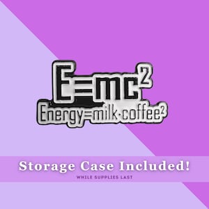May include: A black and white enamel pin with the text "E=mc2" and "Energy=milk.coffee2". The pin is on a purple background. Storage case included.