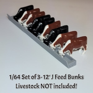 May include: A set of three 12-inch J feed bunks for a 1/64 scale model farm. The bunks are made of gray plastic and are designed to hold livestock feed. The image shows the bunks with miniature cows eating from them.  1/64 Set of 3-12' J Feed Bunks Livestock NOT included!