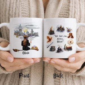May include: Two white ceramic mugs featuring illustrations. The front shows a person on a broomstick with an owl and a castle. The back displays various magical items and the text "We love you Always, Olivia". The name Olivia is printed on the front.