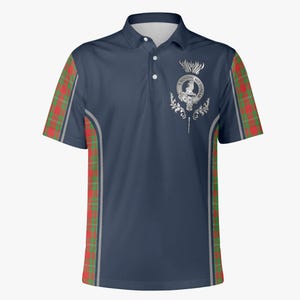 May include: A navy blue polo shirt with a red and green plaid pattern on the sleeves. The shirt features a silver crest with a thistle and the text "MacDonald" on the right chest.