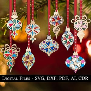 May include: Set of ten laser cut wooden Christmas decorations featuring various geometric patterns in blue, red, green, white, and yellow. The decorations are shaped like teardrops and have a hole at the top for hanging.