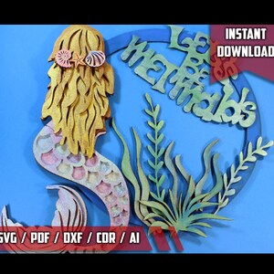 May include: A wooden cutout of a mermaid with a gold and pink tail, surrounded by seaweed and a circle with the text "Let Be Mermaids".