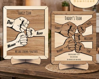 May include: Two rectangular wooden plaques with stands. The left plaque features the text FAMILY TEAM and WE ARE STRONG TOGETHER with illustrations of fists labeled DAD, MOMMY, and ASHLY. The right plaque features DADDY'S TEAM, names KATE, WILLIAM, SAM, and text about a super hero.