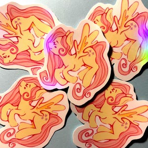 May include: Five die-cut stickers featuring a yellow winged pony with a long, flowing pink mane and tail. The pony has three small purple star-shaped marks on its flank. The design uses bold outlines and a holographic finish that reflects light.