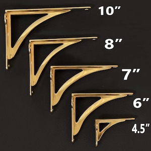 May include: Five gold metal shelf brackets of different sizes, ranging from 4.5 inches to 10 inches. The brackets are arranged in order of size, with the smallest bracket at the bottom and the largest bracket at the top.