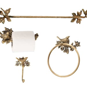 May include: A set of four gold-toned bathroom accessories featuring a bird perched on a branch design. The set includes a towel bar, a toilet paper holder, a towel ring, and a hook.
