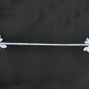 May include: Silver towel bar with a bird and leaf design on each end.