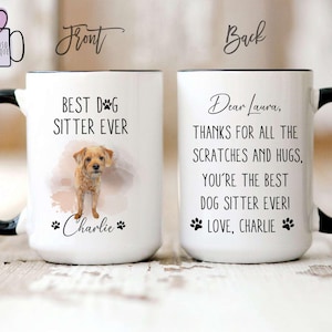 May include: White ceramic mug with a black handle and rim. The front of the mug reads "BEST DOG SITTER EVER" with a watercolor image of a dog and the name "Charlie". The back says "Dear Laura, THANKS FOR ALL THE SCRATCHES AND HUGS, YOU'RE THE BEST DOG SITTER EVER! LOVE, CHARLIE."