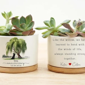 May include: Two white ceramic planters with succulents. One features a weeping willow design and the text "9th anniversary 12.20.2016." The other reads "Like the willow, we have learned to bend with the winds of life, always standing strong together."