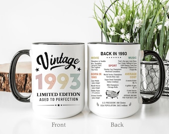 May include: White ceramic mug with a black handle and rim, featuring "Vintage 1993" in a retro design. The mug's front has "Limited Edition Aged to Perfection." The back lists movies, music, sports, and average costs from 1993.