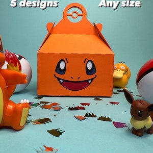 May include: Orange gift box featuring a cartoon face, with the text "5 designs" and "Any size". The box has a handle with a circular design. Various character figurines and confetti are scattered around the box on a light blue surface.