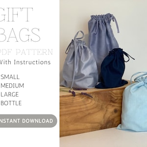 May include: Image of gift bags in various sizes and colors, including light blue, gray, and navy. The bags are made of fabric and have drawstring closures. Text on the left side reads "GIFT BAGS PDF PATTERN With Instructions" and lists sizes: small, medium, large, and bottle.
