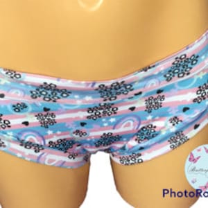 Può includere: Slip a righe bianche, rosa e blu con un motivo a arcobaleno, stelle e stampa leopardata.