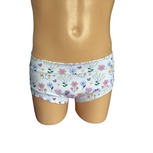 May include: White cotton underwear with a floral print featuring pink, purple, and green flowers and hearts.