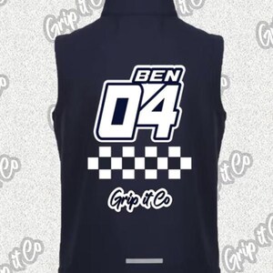 May include: Dark navy vest with a white and blue design. The back displays the name "BEN" above the number "04", a checkered pattern, and the text "Grip it Co."