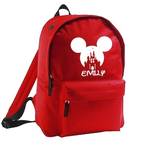 May include: Red backpack featuring a white Mickey Mouse silhouette and castle design. The name "EMILY" is printed below the design.