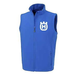 May include: A vibrant blue vest with a full zip and a high collar. The vest displays a white logo on the chest. It has two side pockets and is made from a smooth, robust material. The vest is suitable for outdoor wear and activities.