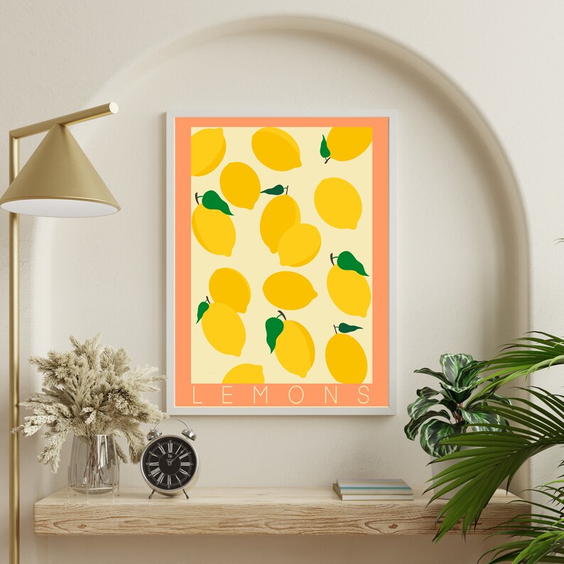 May include: A printable art print with a peach background and white frame featuring a pattern of yellow lemons with green leaves. The text "LEMONS" is printed in white at the bottom of the print.