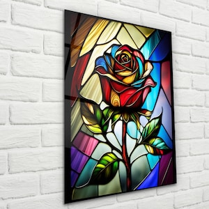 May include: A stained glass style image of a colorful rose with red, yellow, blue, and green hues. The rose is depicted in a traditional stained glass style with intricate details and a black outline.