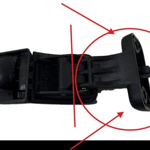 May include: A black plastic automotive part, possibly a door handle or latch component, is shown against a white background. The part has a complex shape with multiple sections, including a rounded knob and a hinged section with mounting holes.