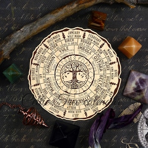 May include: A wooden wheel with a tree of life design and a calendar of the months of the year with corresponding moon phases and holidays. The wheel is decorated with runes and symbols.