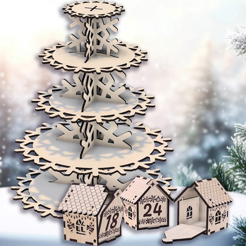 May include: A wooden tiered serving stand with snowflake cutouts and three small wooden house-shaped advent calendar boxes. The stand has four tiers and is made of light-colored wood. The houses have numbers and decorative details.