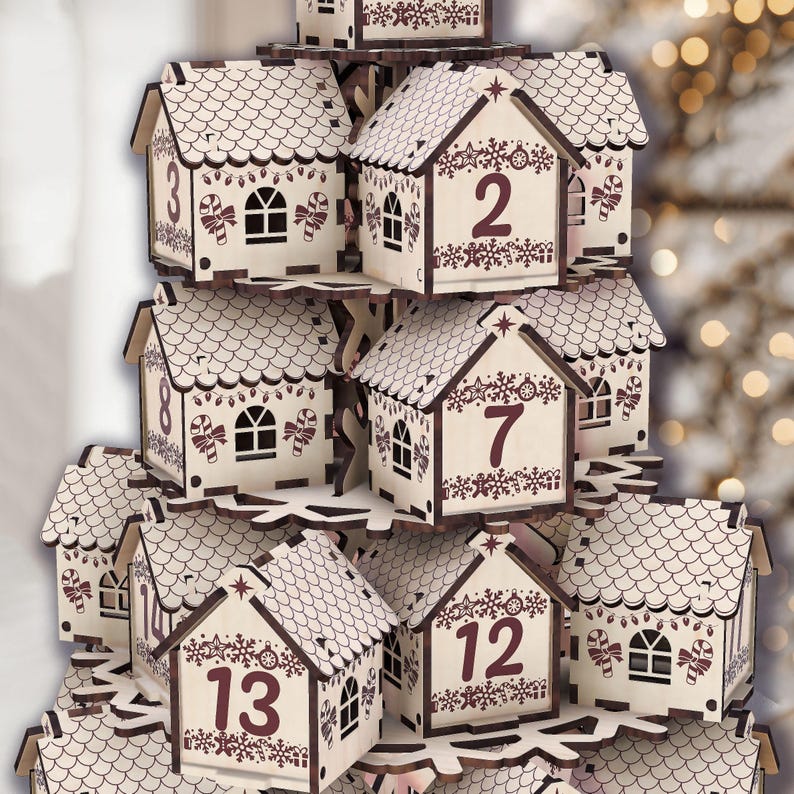 May include: A wooden advent calendar shaped like a tiered village. Each house is numbered and decorated with festive details like candy canes and snowflakes. The houses are light-colored with dark brown accents.