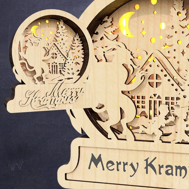 May include: A wooden Christmas ornament with a cut-out design of a reindeer pulling a sleigh with a house and a Christmas tree. The ornament has a light brown finish and features the text "Merry Krampus".