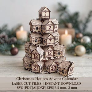 May include: A tiered wooden advent calendar shaped like a tree, composed of small house-shaped boxes with numbered fronts from 1 to 24. The light-colored wood features laser-cut details, including roof shingles, windows, and decorative patterns.