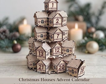 May include: A tiered wooden advent calendar shaped like a tree, composed of small house-shaped boxes with numbered fronts from 1 to 24. The light-colored wood features laser-cut details, including roof shingles, windows, and decorative patterns.