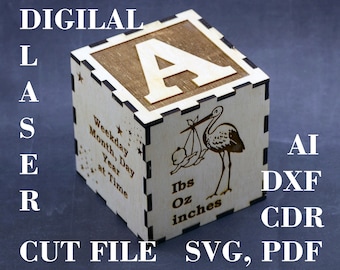 May include: A wooden block with the letter "A" on one side and a stork carrying a baby on the other side. The block also has the text "Weekday, Month, Day, Year at Time" and "Ibs, Oz, inches".
