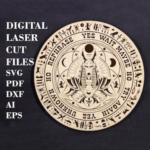 May include: A wooden circular board with a black and white design of an Anubis figure in the center. The board has a circular ring around the Anubis figure with the words "YES", "WAIT", "MAYBE", "NO", "TRY AGAIN", and "REPHRASE" written around the ring. The board is a divination tool.
