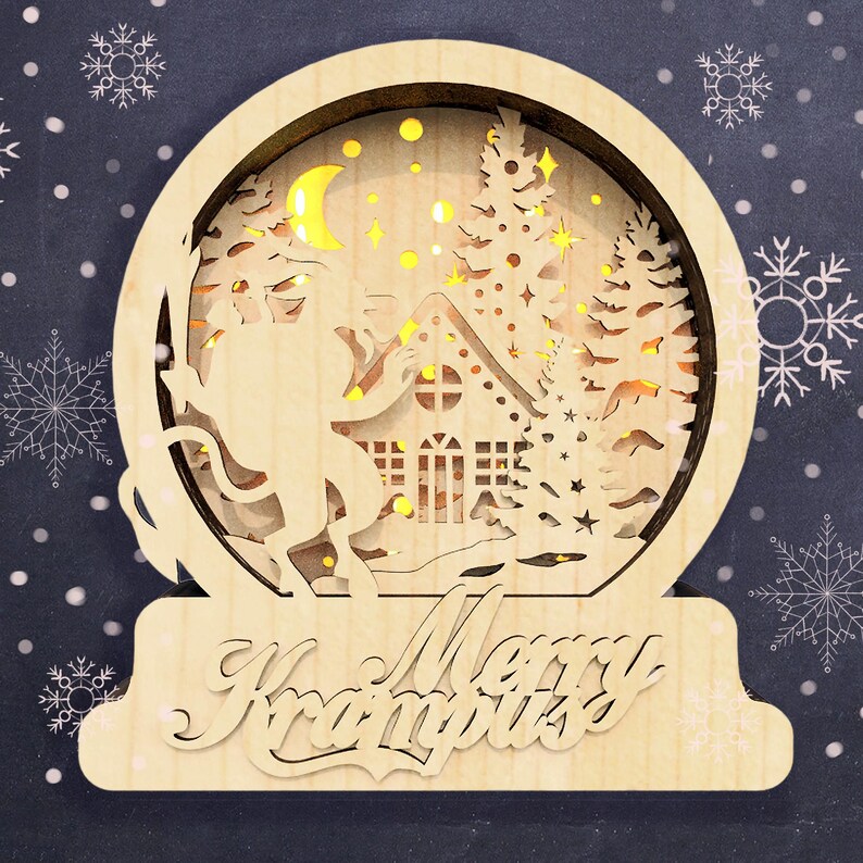 May include: A wooden Christmas snow globe with a light-up scene of Krampus standing in a snowy forest with a house and a crescent moon. The base of the snow globe reads "Merry Krampus".