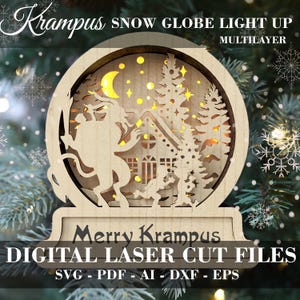 May include: A wooden snow globe light up with a Krampus figure, a house, and trees. The snow globe is decorated with stars and a crescent moon. The text "Merry Krampus" is on the base of the snow globe. The text "DIGITAL LASER CUT FILES SVG - PDF - AI - DXF - EPS" is below the base.