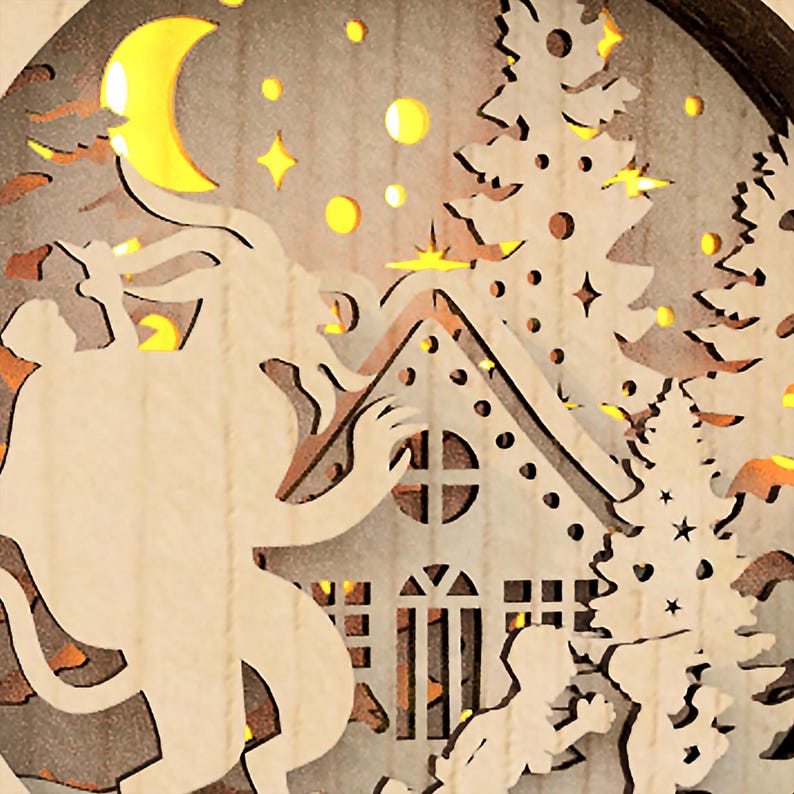 May include: A wooden Christmas ornament with a cutout design of a house, a tree, a crescent moon, and a figure. The ornament is illuminated with warm white LED lights.