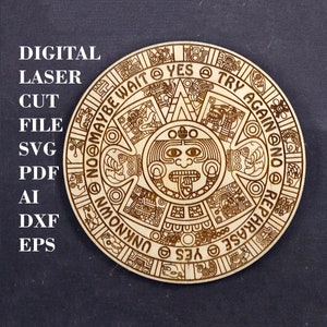 May include: A wooden coaster with a laser-cut design of the Aztec calendar. The design features a central sun god with a face and a circle of glyphs around the outside. The glyphs include the words "YES", "TRY AGAIN", "NO", "MAYBE WAIT", "REPHRASE", and "UNKNOWN".