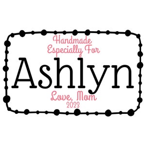 May include: Black and white graphic with a beaded border. The text inside reads "Handmade Especially For Ashlyn Love, Mom 2023".